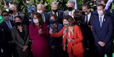 Nancy Pelosi, Speaker of the US House of Representatives, front, and US Rep. Alexandria Ocasio-Cortez, second left, and other US politicians prepare for a group photo at COP26 U.N. (Photo | AP)