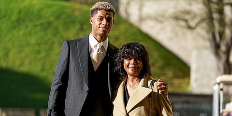 Marcus Rashford with his mother Melanie, arrive at Windsor Castle ahead of an investiture ceremony to receive his MBE for services to vulnerable children in the UK during Covid-19. (Photo | AP)