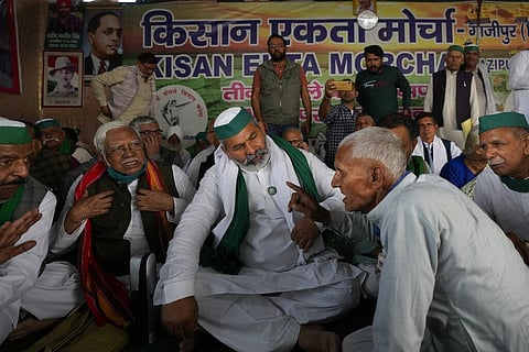 An elderly farmer talks to farmer leader Rakesh Tikait, centre, during a rally at Ghazipur, on the outskirts of New Delhi. (Photo | AP)