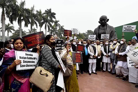 Congress MP Rahul Gandhi with other opposition parties' MPs at a protest near Mahatma Gandhi's statue over suspension of 12 Rajya Sabha MPs, during the Winter Session of Parliament. (Photo | PTI)