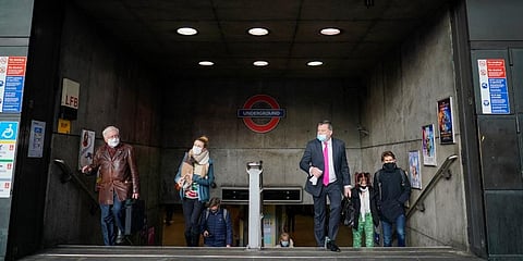 People wear face masks as they exit Westminster underground station, in London. (Photo | AP)