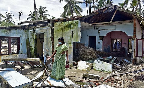 Victory Mathews standing near what is left of her home which was wrecked by sea erosion in Chellanam (Photo | EPS, Albin Mathew)