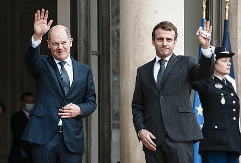 German Chancellor Olaf Scholz, left, is welcomed by French President Emmanuel Macron at the Elysee Palace in Paris. (Photo | AP)