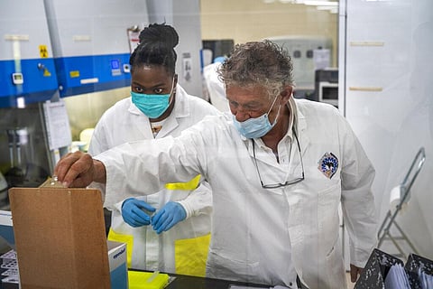 Medical scientist Melva Mlambo, left, works with scientific and medical supervisor Hugo Tempelman in sequencing COVID-19 omicron samples at the Ndlovu Research Center in Elandsdoorn. (Photo | AP)
