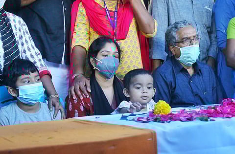 Wife Sreelakshmi and two children beside the body of departed Junior Warrant Officer A Pradeep prior to the cremation. (Photo | A Sanesh, EPS)