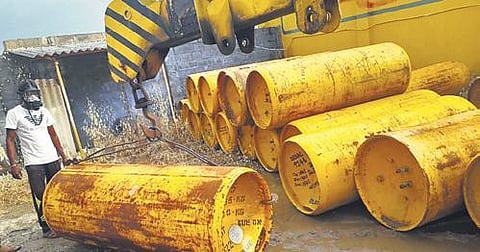 A man in a gas mask moves cylinders at the gas leak site in Erode district on Saturday, Dec 11, 2021. (Photo | Express)