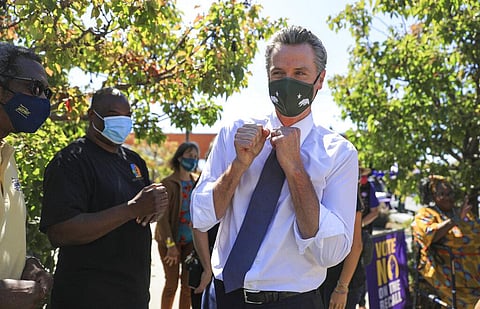 California Gov. Gavin Newsom is greeted by supporters at a rally at St. Mary's Center in Oakland, Calif. (Photo | AP)