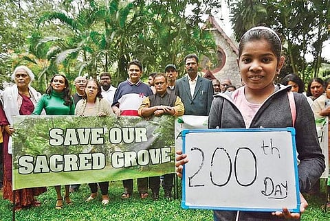 Members of All Saints Church protest against BMRCL, asking it to protect the 150-year-old church, its trees, and urban wildlife, near Vellara Junction Signal, Hosur Road on Sunday. (Photo | EPS/Shri