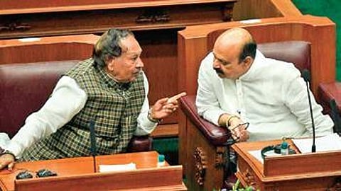 CM Basavaraj Bommai in conversation with RDPR minister KS Eshwarappa during the session on Monday. (Photo | EPS)
