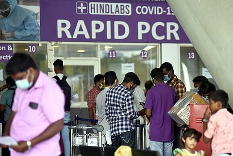 Air passengers waiting near Rapid PCR registration counter at Chennai international airport. (Photo | Martin Louis, EPS)