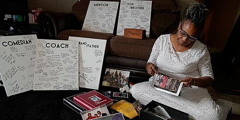 Carolyn Burnett sorts through mementos to select items to commemorate her son Chris Burnett in Olathe, Kan. (Photo | AP)