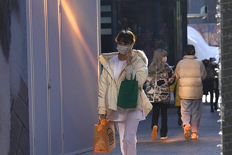 A woman wear masks as she visits a shopping mall in Beijing, China, Tuesday, Dec. 14, 2021. (Photo | AP)