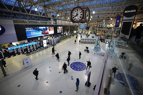 People pass through during the morning rush-hour at Waterloo railway station in London, Tuesday, Dec. 14, 2021. (Photo | AP)
