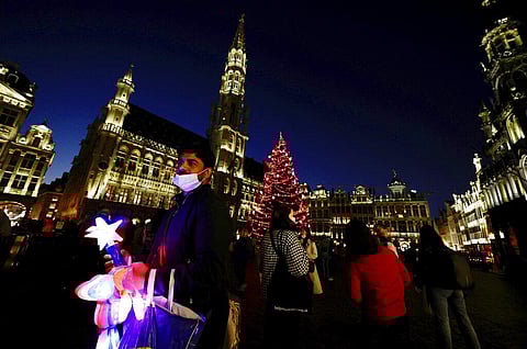 A man sells illuminated ornaments in the historical Grand Place in the center of Brussels, Thursday, Dec. 16, 2021. (Photo | AP)
