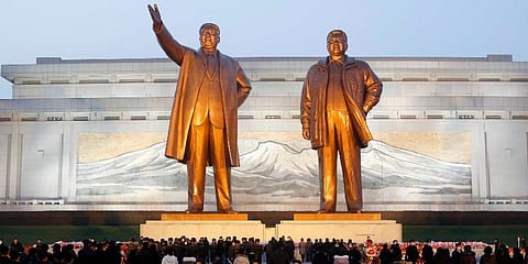 North Koreans visit the bronze statues of Kim Il-sung, left, and Kim Jong-il on Mansu Hill in Pyongyang, Dec. 16, 2021, on the occasion of 10th anniversary of demise of Kim Jong-il. (Photo | AP)