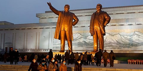 North Koreans visit the bronze statues of Kim Il Sung, left, and Kim Jong Il on Mansu Hill in Pyongyang, Dec. 16, 2021, on the occasion of 10th anniversary of demise of Kim Jong Il. (Photo | AP)