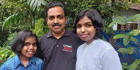 Niveditha D (L) and Nanditha D with their father P Devaraj. (Photo | Special Arrangement)