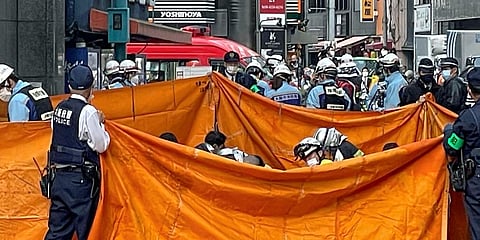 Rescuers attend to victims following a fire at a building in Osaka, western Japan Friday, Dec. 17, 2021. (Photo | AP)