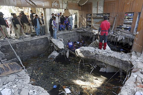 Rescuers inspect the scene of a gas explosion in Karachi, Pakistan, Saturday, Dec. 18, 2021. (Photo | AP)