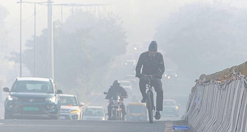 Vehicles ply amid low visibility due to smog on a cold winter morning in Gurugram on Friday | Pti