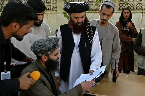 Alam Gul Haqqani (C), head of the passport office, says the Taliban will resume issuing passports after a deluge of applications caused biometric equipment to break down. (Photo | AFP)