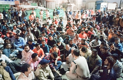 The youths on a sit-in protest at dharmaveer Sambhaji circle in Belagavi on Friday night (Photo | EPS)