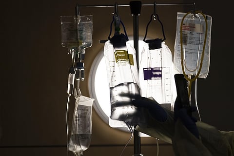 A nurse checks on IV fluids while talking to a COVID-19 patient at Providence Holy Cross Medical Center in Los Angeles, Monday, Dec. 13, 2021. (Photo | AP)