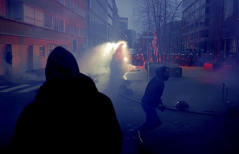Protestors run in front of a police line during a demonstration against COVID-19 measures in Brussels, Sunday, Dec. 19, 2021. (Photo | AP)