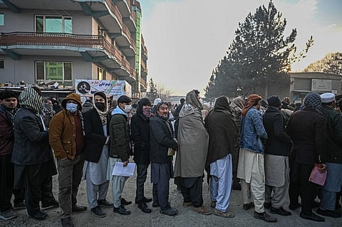 People queue to enter the passport office at a checkpoint in Kabul on December 19, 2021, after Afghanistan's Taliban authorities said they will resume issuing passports. (Photo | AFP)