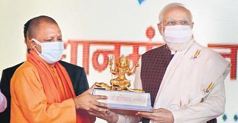 Modi and Yogi at the stone laying ceremony in UP’s Shahjahanpur on Saturday. (Photo | PTI)