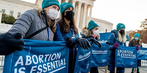 Abortion rights advocates hold signs that read 'Abortion is Essential' as they demonstrate in front of the U.S. Supreme Court, Wednesday, Dec. 1, 2021, in Washington. (Photo | AP)