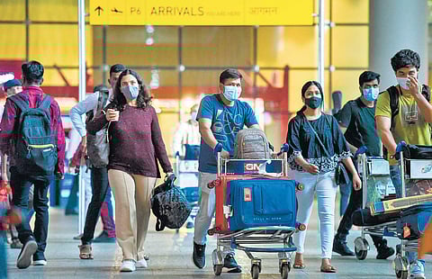 Arriving passengers leave a terminal at the Chhatrapati Shivaji Maharaj International Airport in Mumbai. | AFP