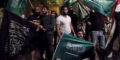 Lebanese hold Saudi Arabian flags during a rally in support of the kingdom against comments made by Lebanon's Information Minister George Kordahi over the war in Yemen. (Photo | AP)