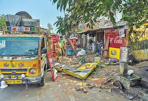 A pan shop owner salvaging useful things after VMC staff cleared encroachments at Gunadala Centre in Vijayawada on Monday | Prasant Madugula
