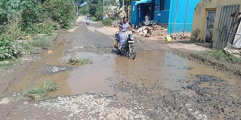 A woman riding a two-wheeler on the road towards Zoological park from Gorimedu | Express