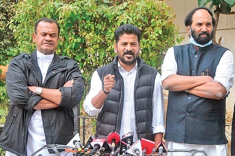 Flanked by Uttam Kumar Reddy and Komatireddy Venkatreddy, TPCC chief A Revanth Reddy makes a point during his press conference in New Delhi on Wednesday, Dec 22, 2021.