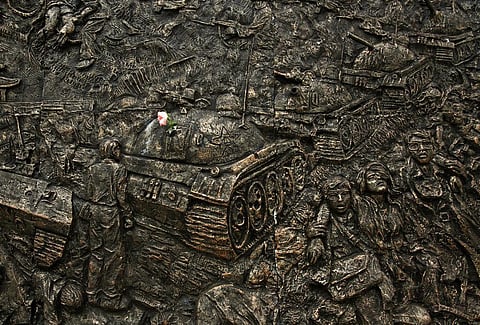 A flower is put in the barrel of a tank in a relief depicting the pro-democracy movement in Lingnan University,the monument was removed by the University. (Photo | AP)