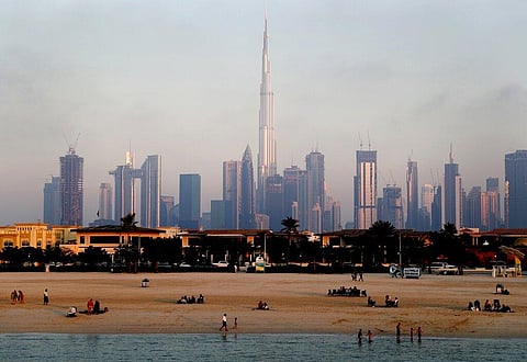 People enjoy the beach in front of the city skyline with the world tallest tower, Burj Khalifa, in Dubai, United Arab Emirates, Friday, Feb. 12, 2021. (Photo | AP)