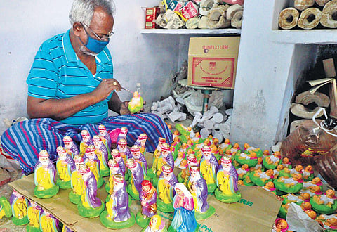 A worker adds the finishing touches to dolls prepared for Christmas, in Vilachery near Madurai | KK SUNDAR