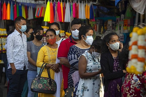 Indian Christians wearing face masks as a precaution against the COVID-19, wait for their turn to enter a church to offer prayers on Christmas in Mumbai. (Photo | AP)
