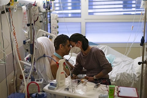 Amelie and Ludo Khayat hold each other during a visit at the COVID-19 intensive care unit of the la Timone hospital in Marseille, southern France. (Photo | AP)