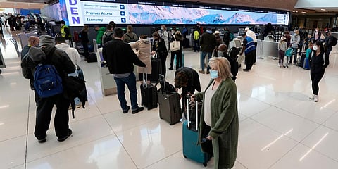 Travellers queue up at the United Airlines check-in kiosks in the terminal of Denver International Airport. (Photo| AP)