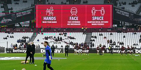 COVID-19 safety signage are seen above the stands before a Premier League match between West Ham and Southampton, at the London Stadium. (Photo| AP)
