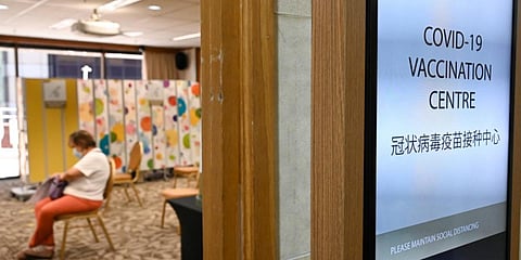 A woman waits to receives a dose of the Sinopharm COVID-19 vaccine at the Mount Elizabeth hospital vaccine centre in Singapore. (Photo| AFP)