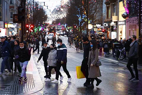 Shoppers, some wearing face masks to guard against COVID-19, cross Oxford Street in London, Monday, Dec. 27, 2021. (Photo | AP)