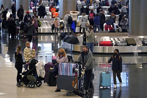 Travelers pass through Salt Lake City International Airport Monday, Dec. 27, 2021, in Salt Lake City.. (Photo | AP)