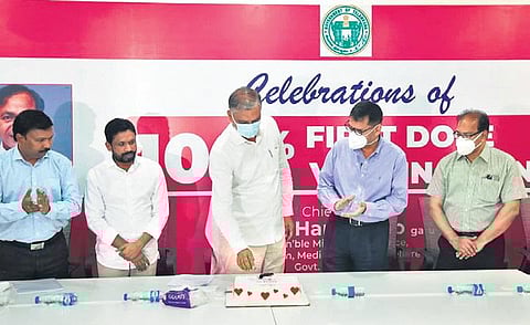 Health Minister T Harish Rao cuts a cake to celebrate Telangana’s milestone in becoming the first large state to achieve 100 per cent first-dose vaccination