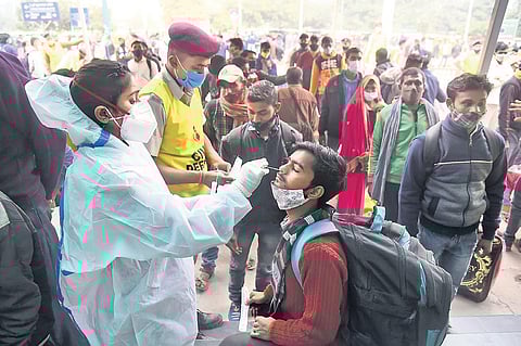A health worker takes swab sample for COVID-19 test at Anand Vihar Railway Station. (Photo | Parveen Negi, EPS)