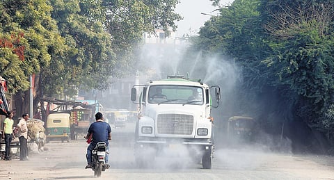 An anti-smog tanker sprays water into the air to reduce dust pollution in New Delhi. (Photo | Parveen Negi, EPS)