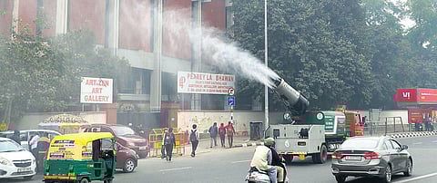 An anti smog gun installed on a truck sprinkles water to curb pollution at ITO in New Delhi. (Photo | Shekhar Yadav, EPS)